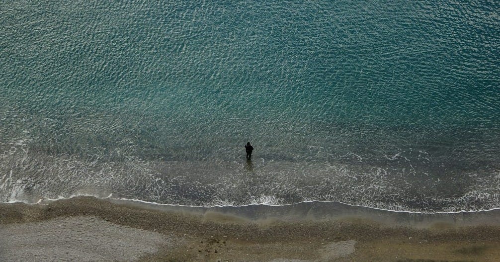 person standing on shoreline