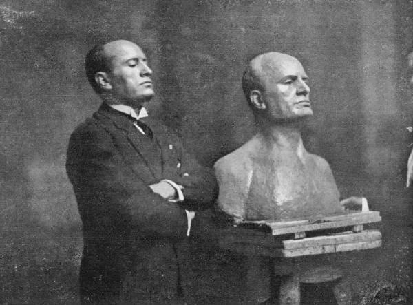 Benito Mussolini striking a pose next to a bust of himself in 1926, reflecting his growing cult of personality. Benito Mussolini striking a pose next to a bust of himself in 1926, reflecting his growing cult of personality.
