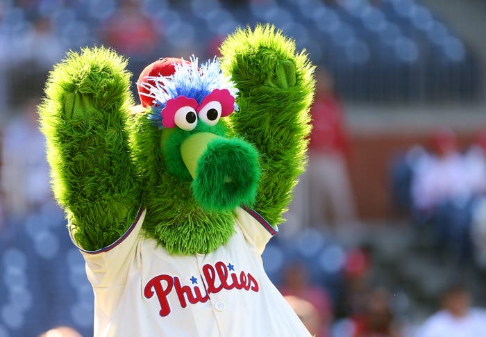 The Phillie Phanatic mascot raising its arms.
