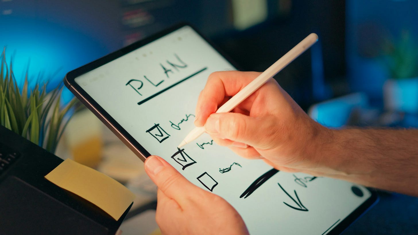 Person writing a checklist on a digital tablet with the word "PLAN" at the top, symbolizing organization and financial planning. Photo by Jakub Zerdzicki on Unsplash