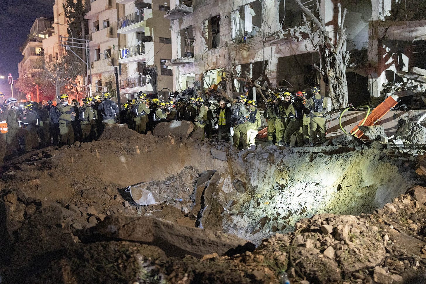 Israeli rescue forces at the scene where a ballistic missile fired from Iran hit a residential area in central Tel Aviv, February 28, 2026. (Oren Ziv) Israeli rescue forces at the scene where a ballistic missile fired from Iran hit a residential area in central Tel Aviv, February 28, 2026. (Oren Ziv)