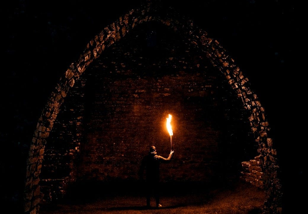 person holding torch in building interior person holding torch in building interior