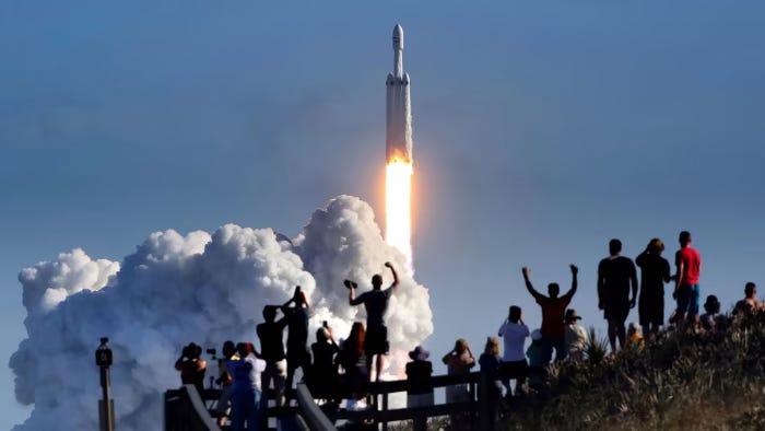dpatop - People watch as SpaceX Falcon Heavy rocket blasts off from Pad 39A at the Kennedy Space Center in Florida, US, 06 February 2018. Photo: Joe Burbank/Orlando Sentinel/dpa dpatop - People watch as SpaceX Falcon Heavy rocket blasts off from Pad 39A at the Kennedy Space Center in Florida, US, 06 February 2018. Photo: Joe Burbank/Orlando Sentinel/dpa