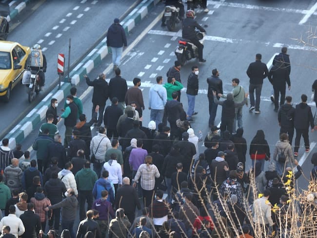 Shopkeepers and traders protest in the street against the economic conditions and Iran's embattled currency in Tehran on December 29, 2025. Some shopkeepers in Tehran closed their stores on December 29 in protest against economic hardships and sharp swings in Iran's embattled currency, Iranian media reported, following similar demonstrations a day earlier. Iran's currency has hit new lows on the unofficial market, with the US dollar trading at around 1.42 million rials on Sunday, compared to 820,000 rials a year ago and the euro nearing 1.7 million rials, according to price monitoring websites. (Photo by HANDOUT / FARS NEWS AGENCY / AFP) Shopkeepers and traders protest in the street against the economic conditions and Iran's embattled currency in Tehran on December 29, 2025. Some shopkeepers in Tehran closed their stores on December 29 in protest against economic hardships and sharp swings in Iran's embattled currency, Iranian media reported, following similar demonstrations a day earlier. Iran's currency has hit new lows on the unofficial market, with the US dollar trading at around 1.42 million rials on Sunday, compared to 820,000 rials a year ago and the euro nearing 1.7 million rials, according to price monitoring websites. (Photo by HANDOUT / FARS NEWS AGENCY / AFP)