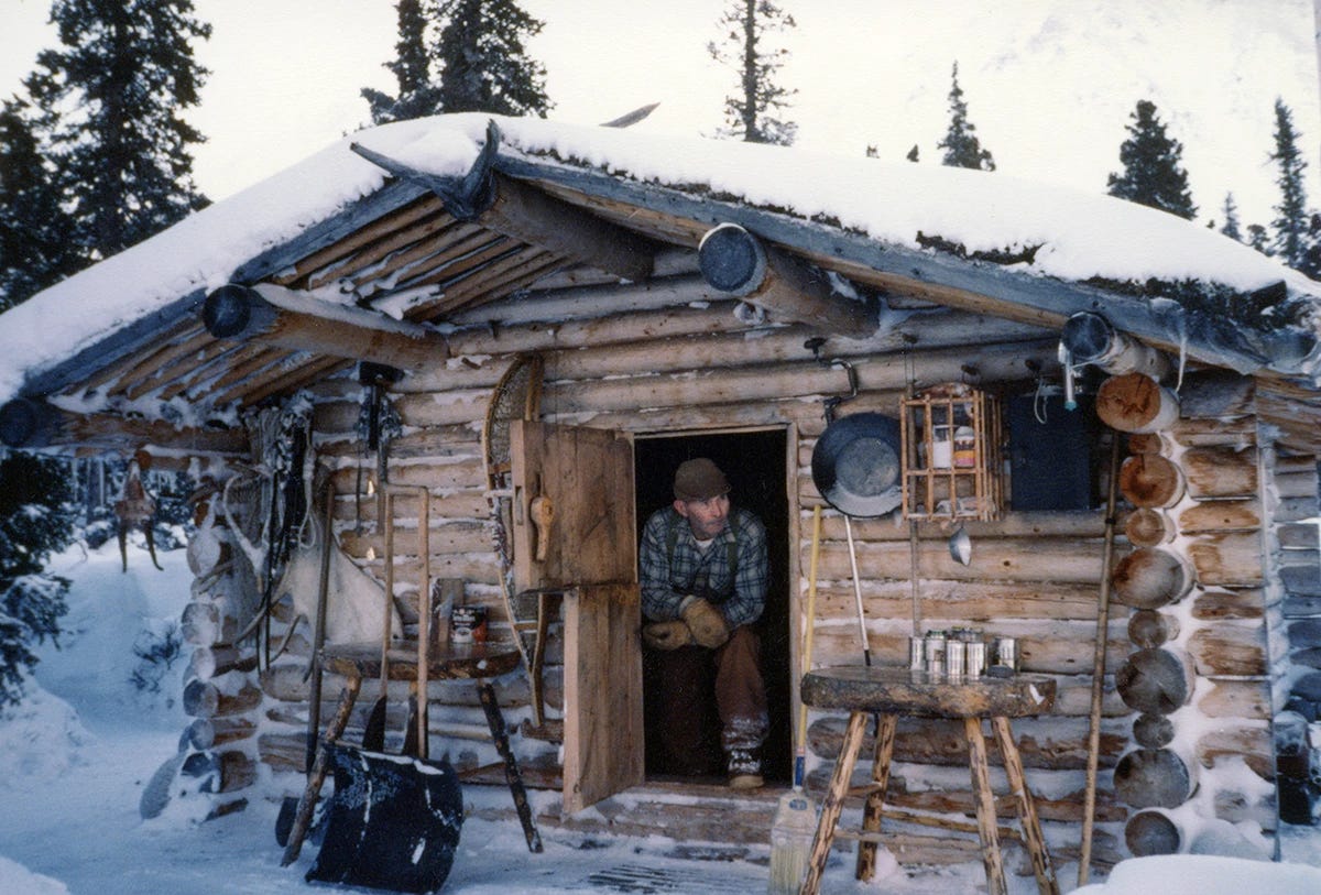 Dick Proenneke looking out the front door of his Alaska cabin. Dick Proenneke looking out the front door of his Alaska cabin.