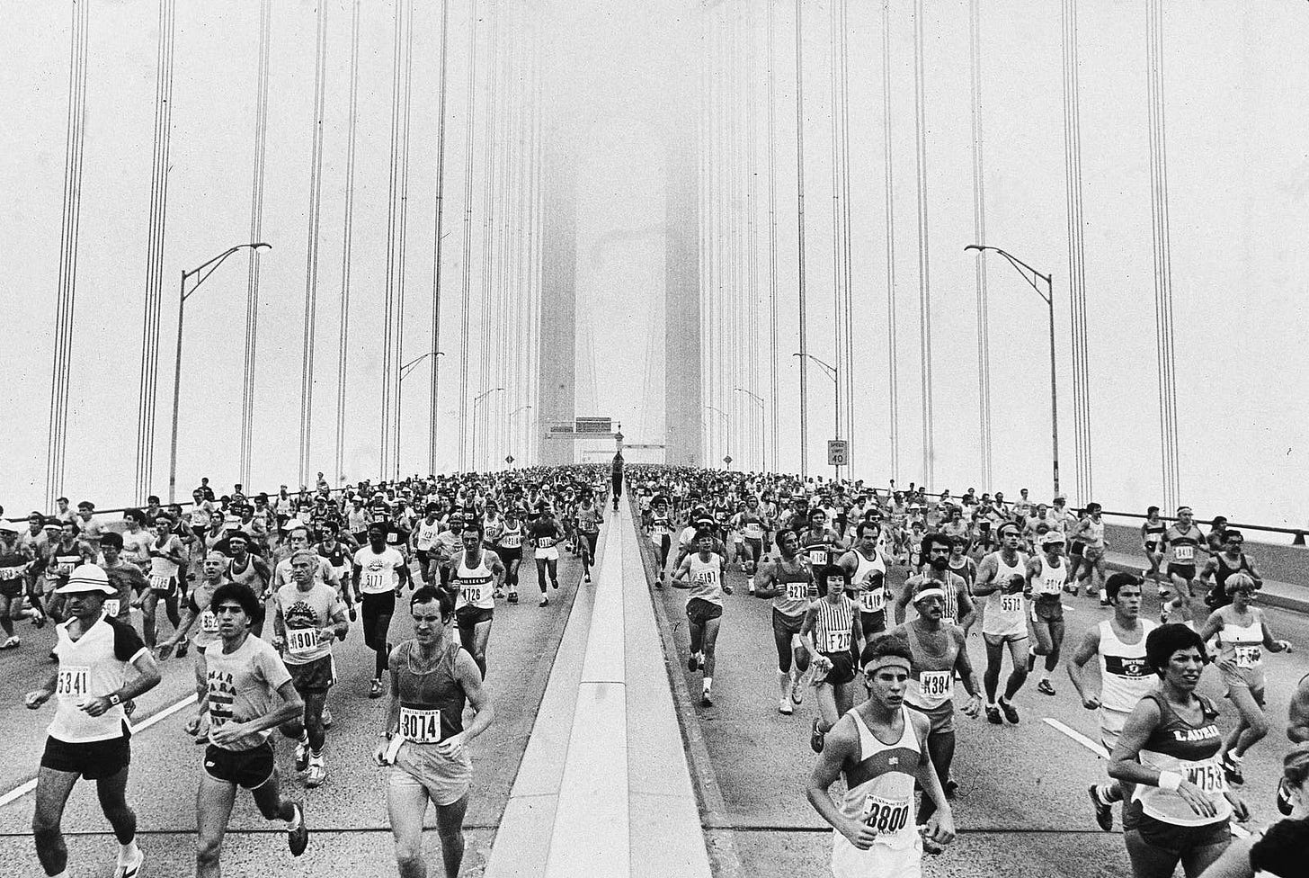 Wide black-and-white shot of runners Wide black-and-white shot of runners