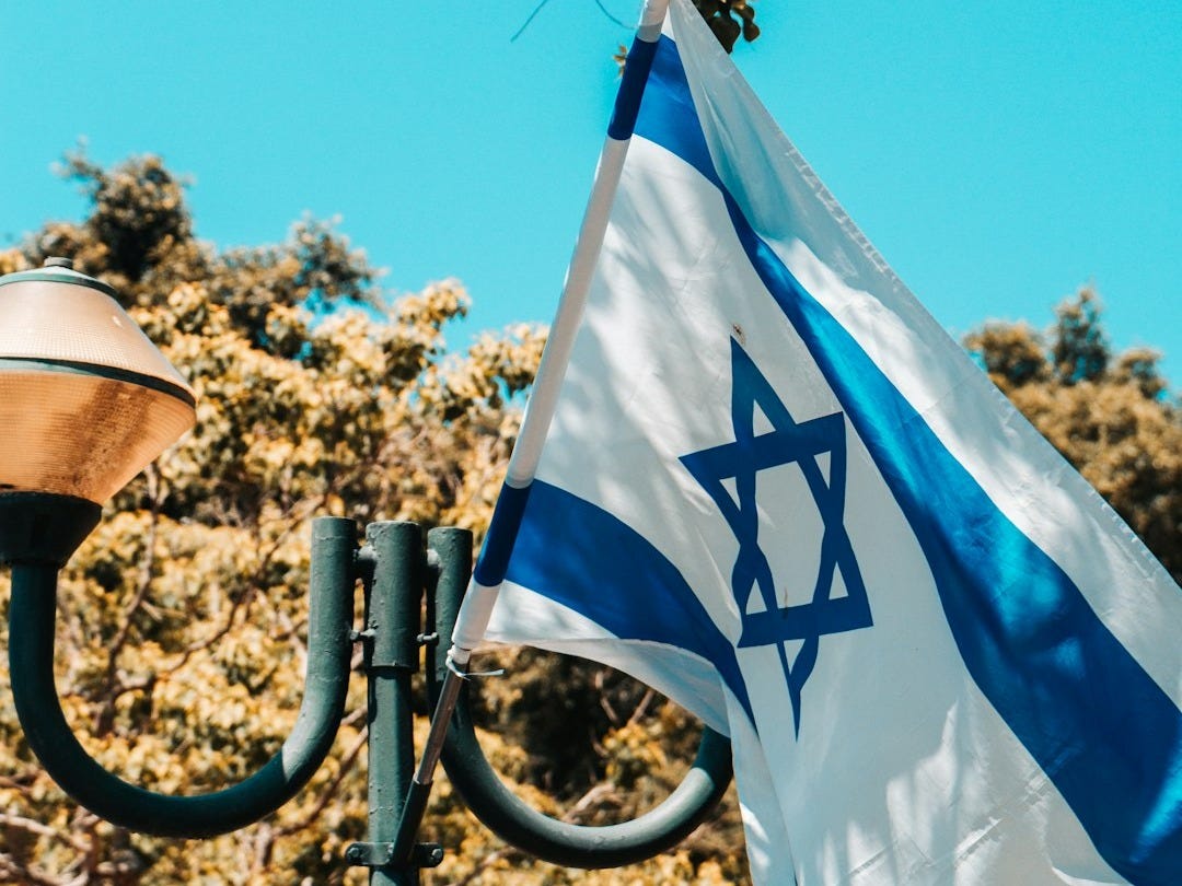 the israeli flag is flying in the wind