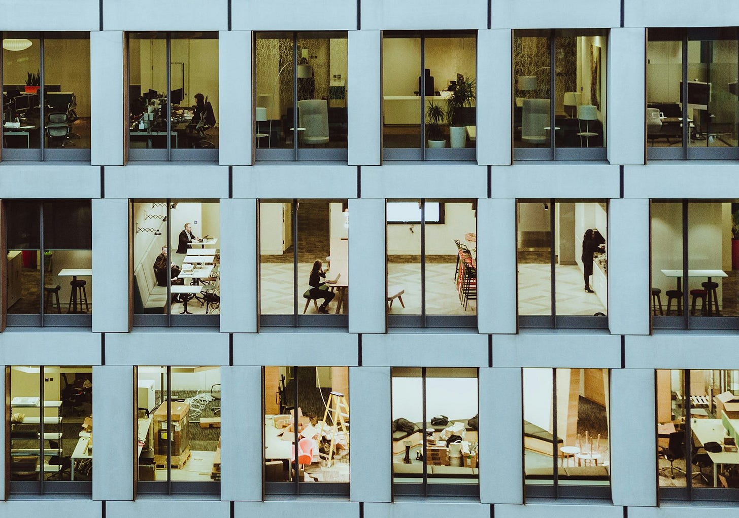 people inside high-rise building with concrete wall people inside high-rise building with concrete wall