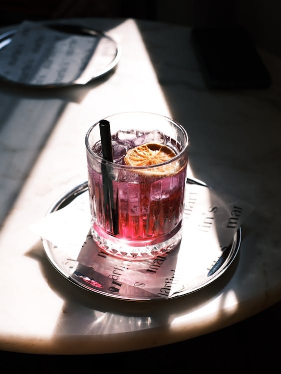 Free A colorful cocktail with a citrus garnish, perfect for social gatherings. Stock Photo