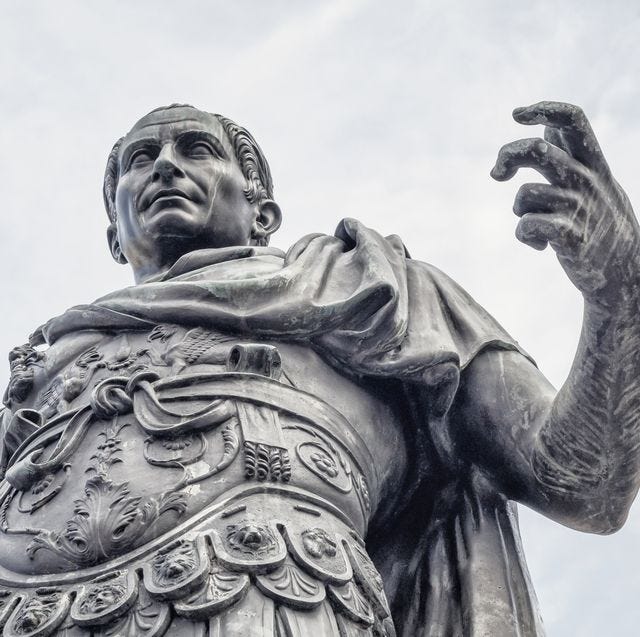 statue of a man wearing armor as he makes an assertive gesture