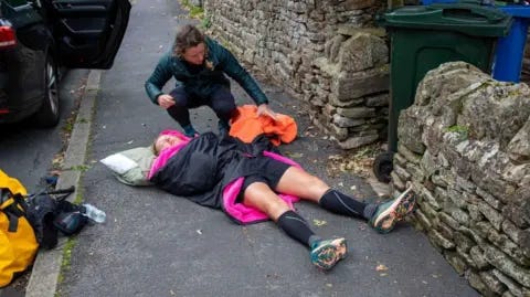 Lucy Gossage Lucy Gossage lying on the ground, covered by a blanket at the end of her Pennine Challenge Lucy Gossage Lucy Gossage lying on the ground, covered by a blanket at the end of her Pennine Challenge