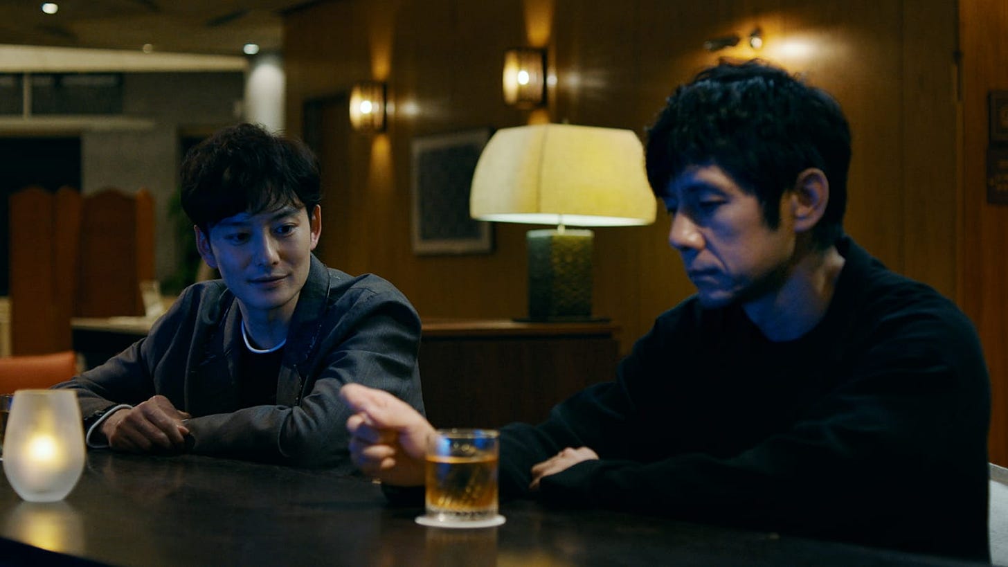 Drive My Car | Still features Hidetoshi Nishijima as Yusuke Kafuku next to Masaki Okada as Koji Takatsuki at a bar.