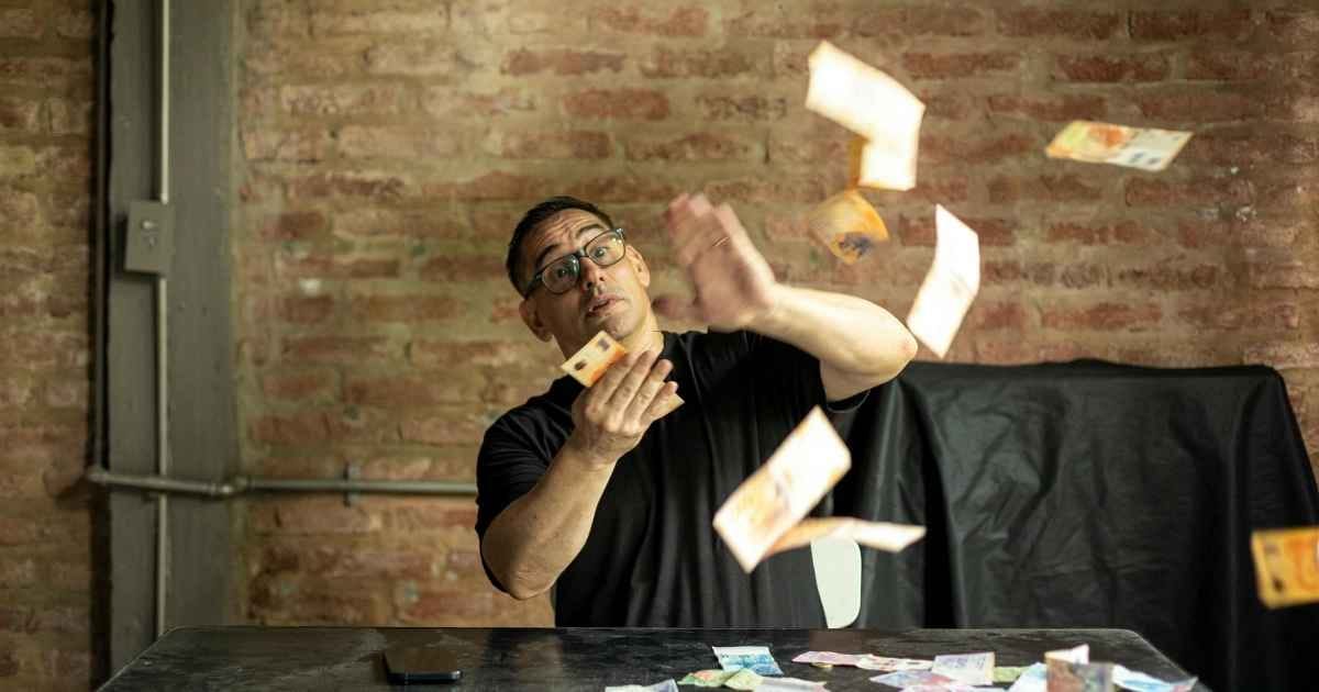 Man throwing Argentine pesos indoors in Buenos Aires Man throwing Argentine pesos indoors in Buenos Aires