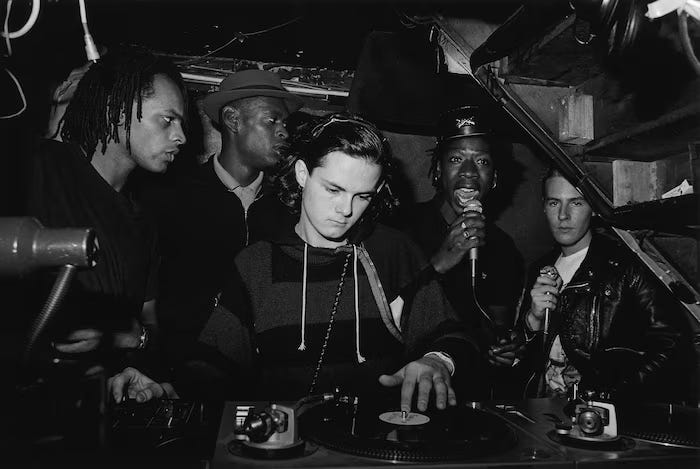 Left: Milo, Daddy G, Nellee Hooper, Willie Wee, and 3D at Dug Out, 1984. |. Right: Daddy G, Willie Wee, Nellee Hooper, and Milo Johnson in 1985. |. Beezer / PYMCA