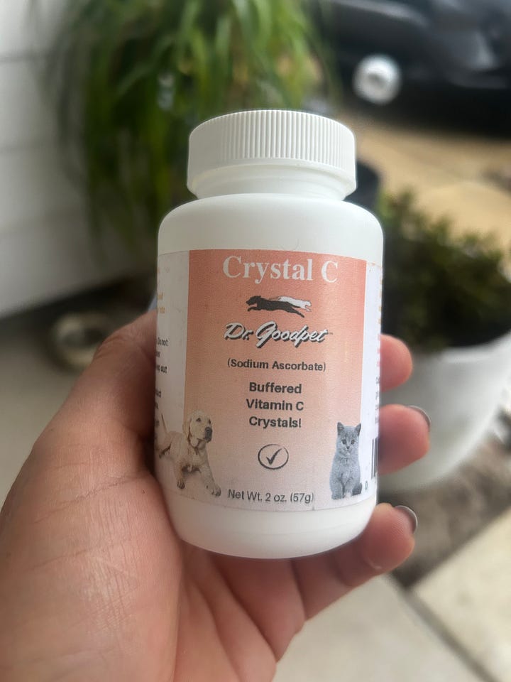 Photo gallery showing the supplements and therapies used during Mookie's recovery, including feline colostrum, probiotics, vitamin C, and a Sonic Slider weighted tuning fork for sound therapy.