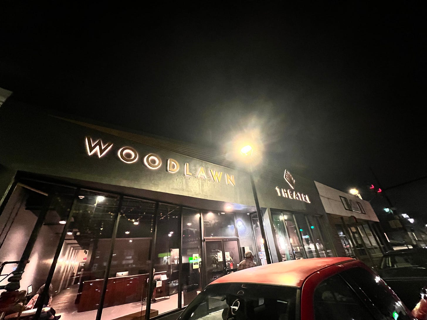 the outside of the woodlawn theater at night