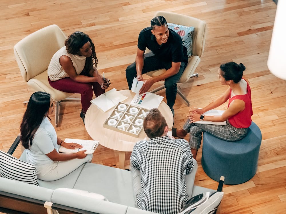 Free People at the Office Lobby Having a Discussion Stock Photo