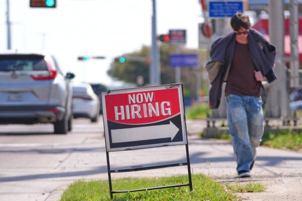 A now hiring sign sits on the side of the road in Garland, Texas, Monday, March 23, 2026. (AP Photo/LM Otero) A now hiring sign sits on the side of the road in Garland, Texas, Monday, March 23, 2026. (AP Photo/LM Otero)