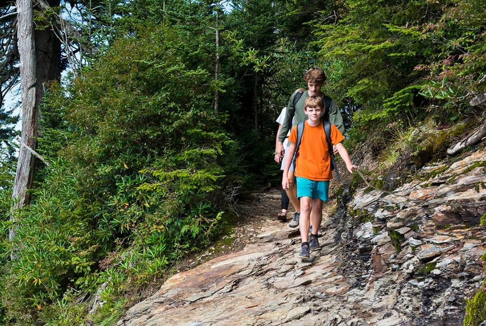 family hiking on trail