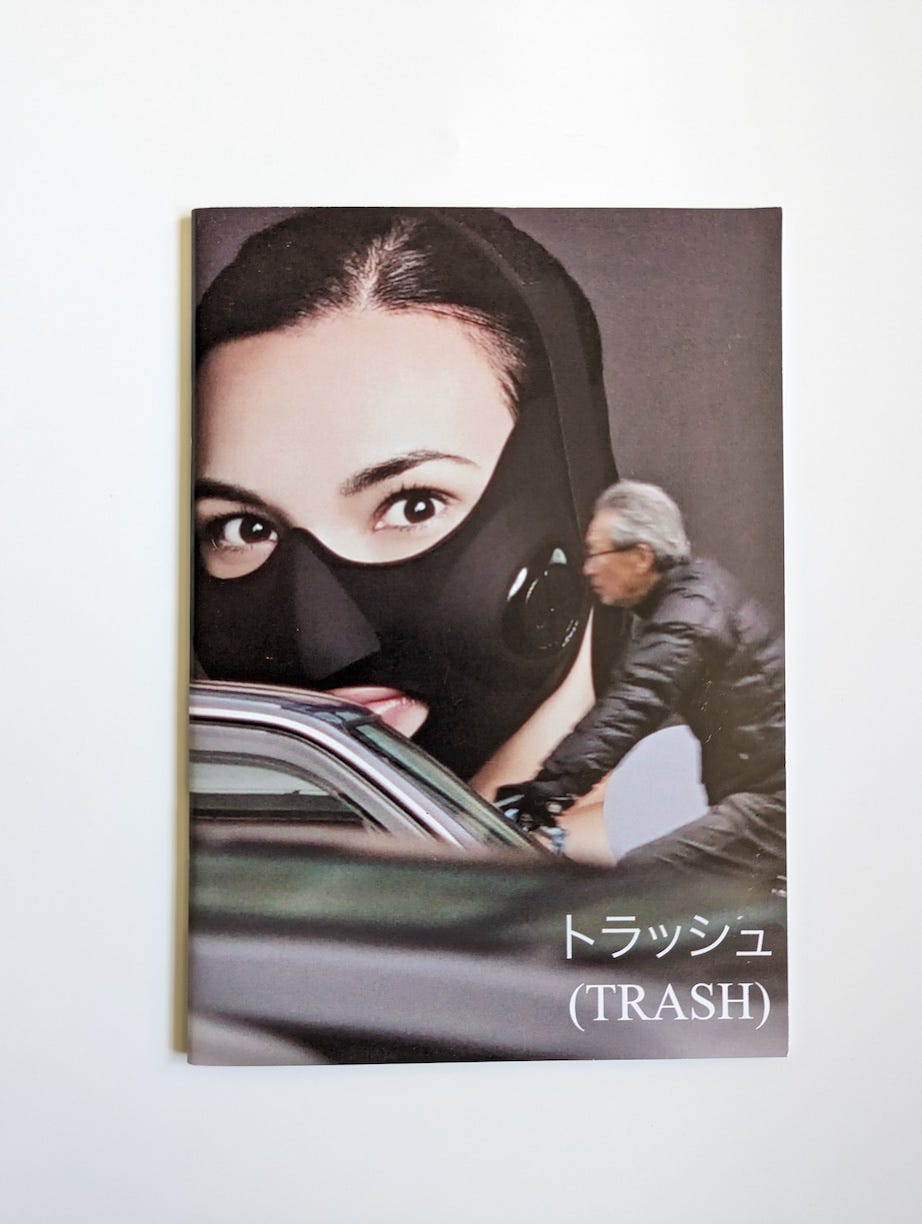 Cover of Tokyo Trash Zine, a rare photography zine documenting Tokyo's graffiti, handstyles, and street culture. The cover features a striking collage of a masked woman, a blurred cyclist in motion, and Japanese text reading 'トラッシュ (TRASH),' capturing the raw, layered aesthetics of urban life.