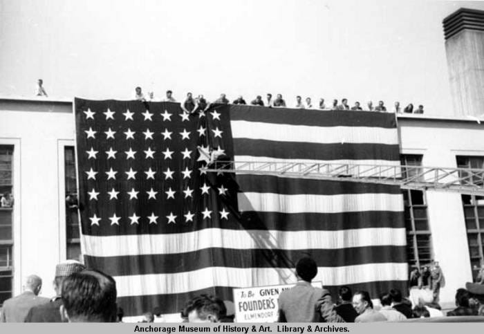 Gigantic American flag draped over the side of the Federal building in downtown Anchorage, Alaska celebrating statehood in 1958.