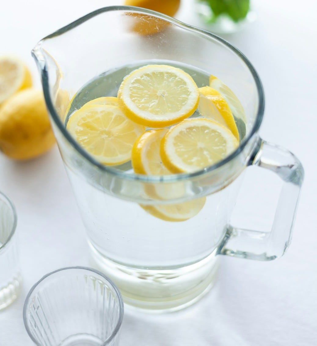 slices of lemons in clear pitcher filled with water