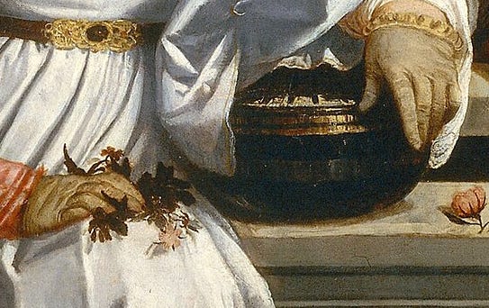 Close view of the bride's waist, the belt fastened high with a gold buckle.