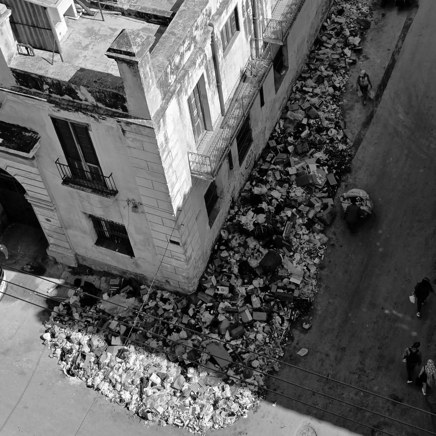 A building surrounded by rubble, seen from above at an angle A building surrounded by rubble, seen from above at an angle