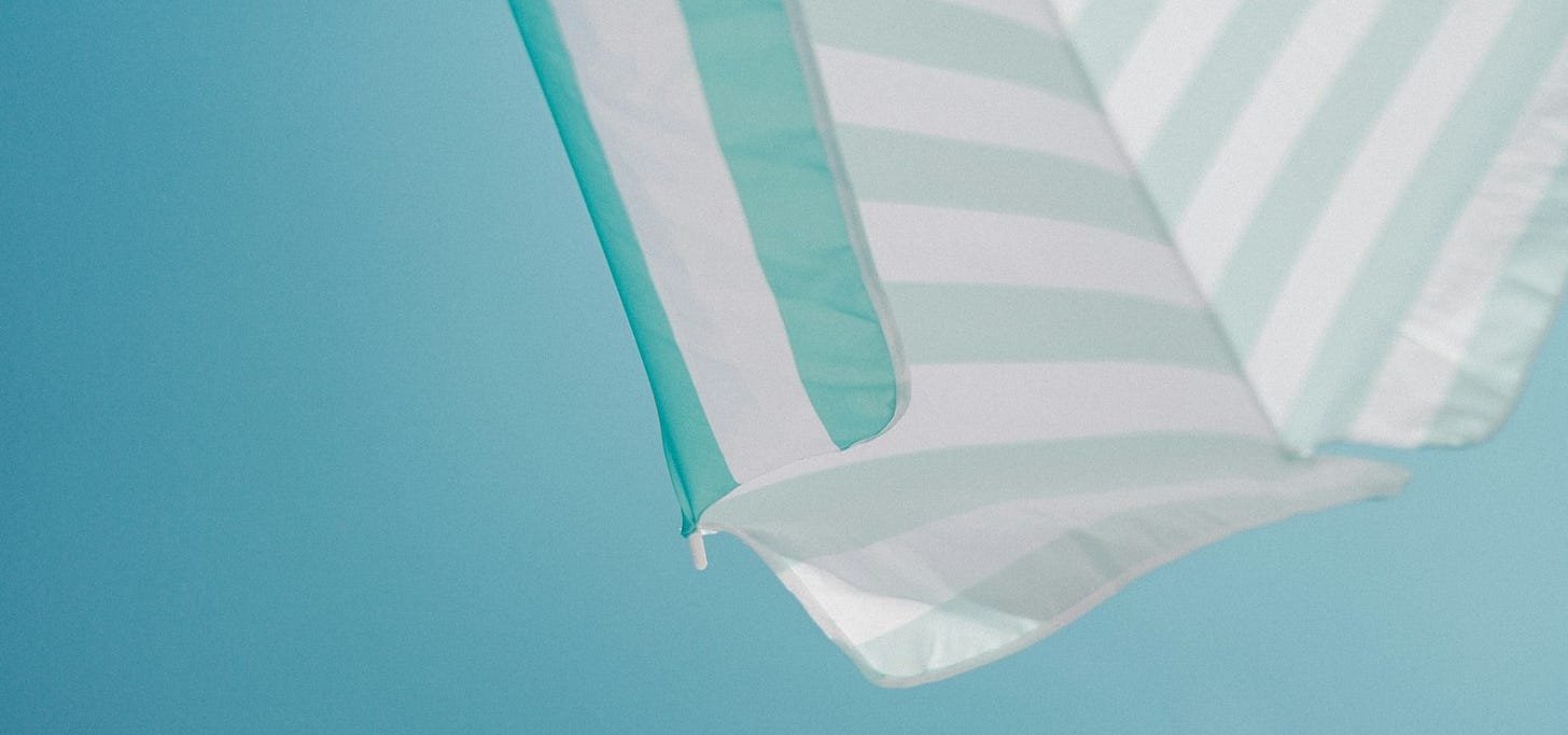 white and green striped parasol during daytime photo white and green striped parasol during daytime photo