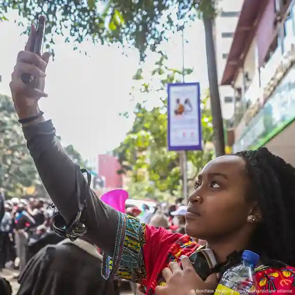 A young woman takes a selfie at a protest against tax increases in Nairobi, Kenya