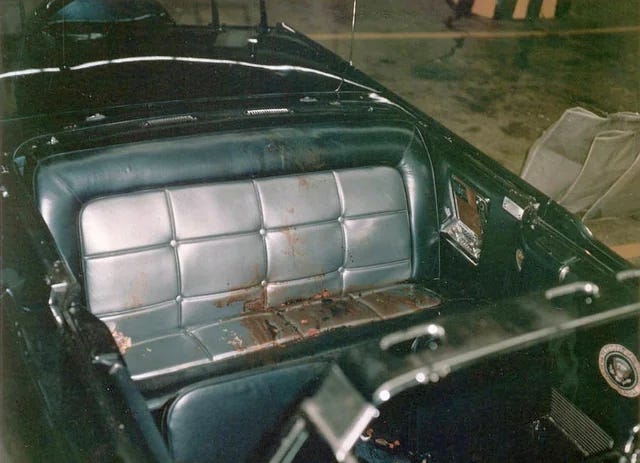 The somber rear seat of JFK's limousine immediately after the assassination in 1963, a stark image of a nation in shock.