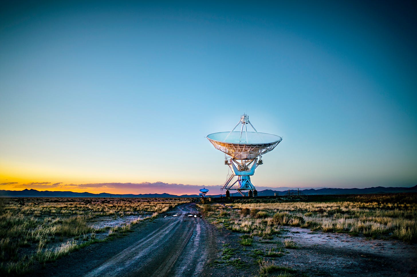 Satellite dishes in a scrub-covered desert
