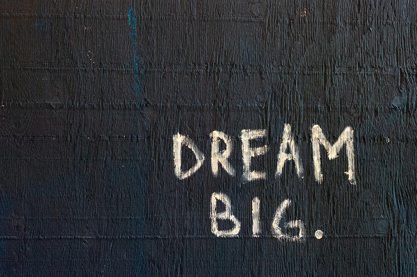 The words DREAM BIG painted on a wall
