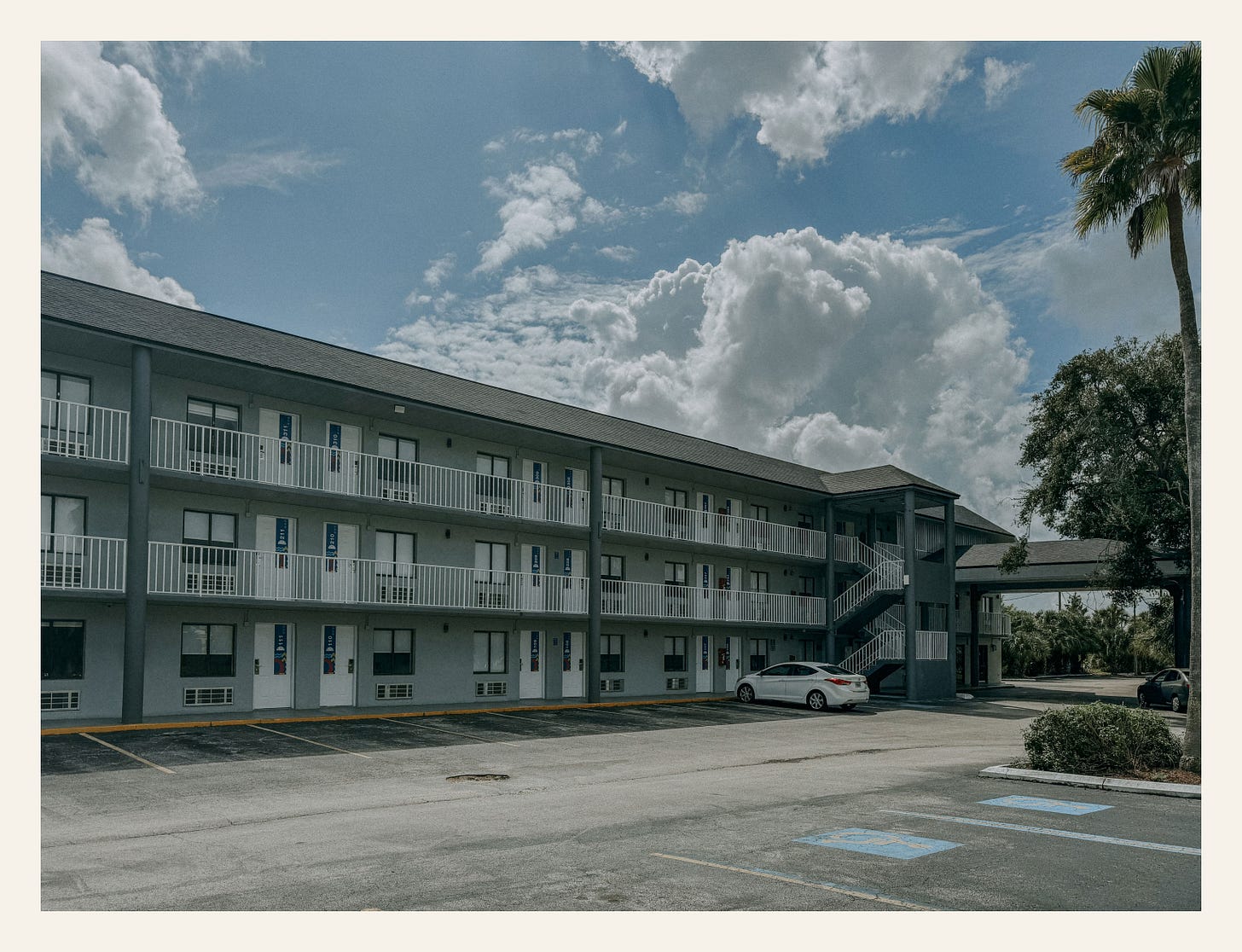 Former Magic Castle Motel in Kissimmee, Florida – once purple with turrets, now painted plain white by new owners