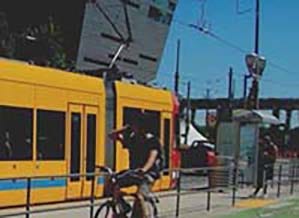 bicyclist and light rail train and station bicyclist and light rail train and station
