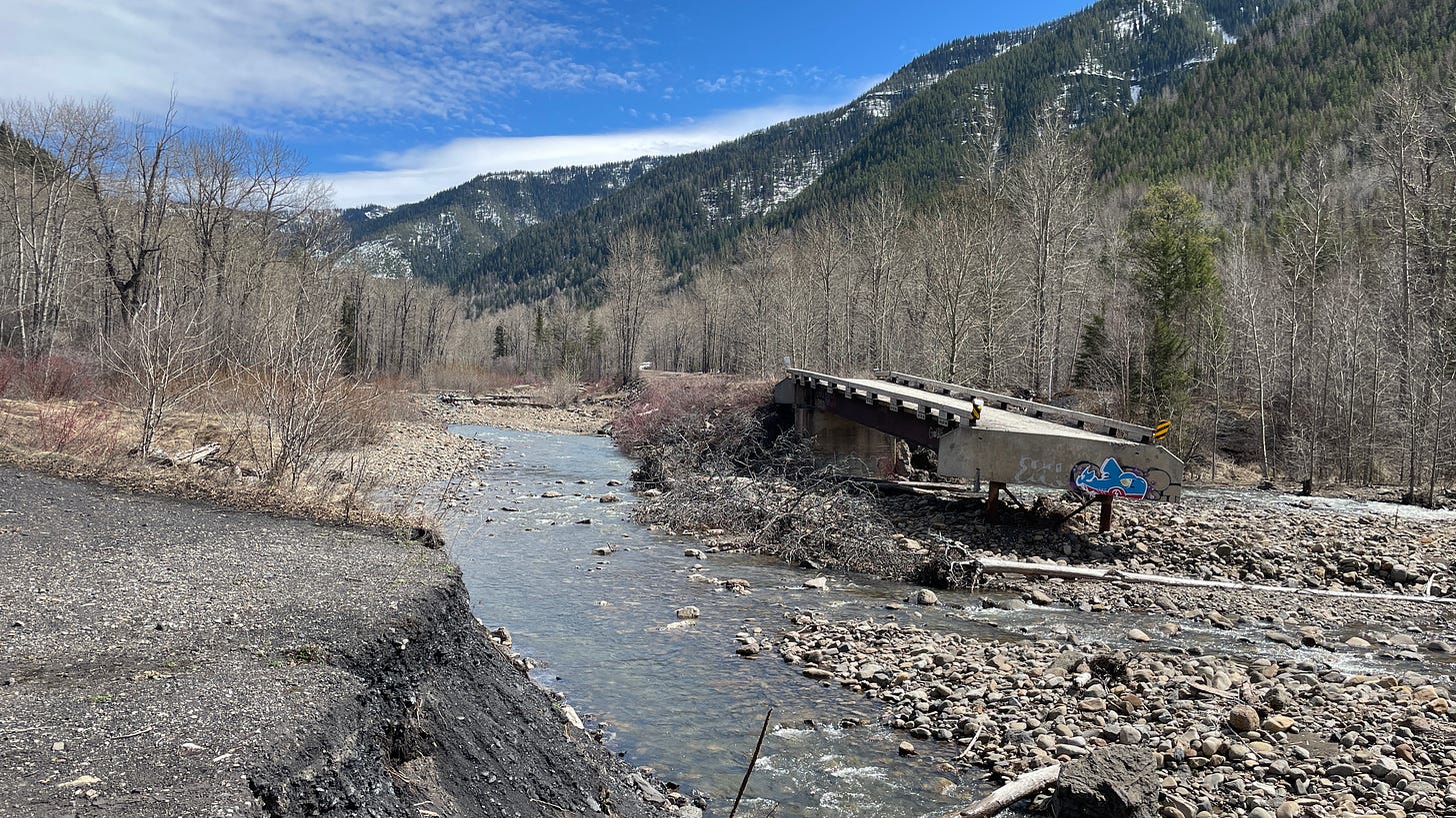 Landscape wide shot, blue skies, collapsed bridge graffiti