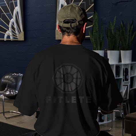 The toned fitlete logo sits on top of a shirt with its same color at a different shade or tone.