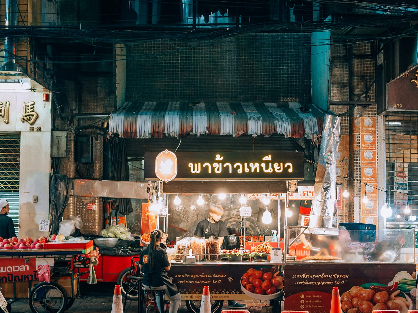 a street scene with traffic cones and a food stand a street scene with traffic cones and a food stand