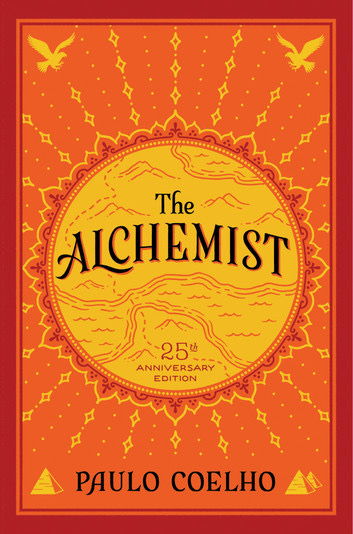 Pictured is the notoriously bright orange cover with the title “The Alchemist” in black font inside of a golden circle. The golden circle is placed in the middle with diamond embellishments stretching around it in the shape of sun rays. In the bottom corners are pyramids, and the top corners are falcons.