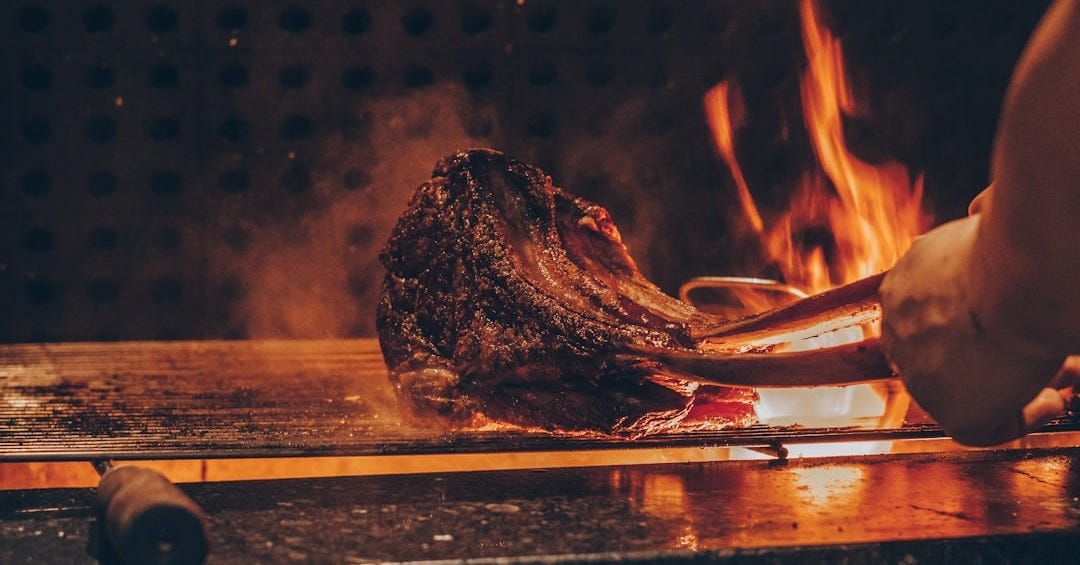 person barbecuing meat