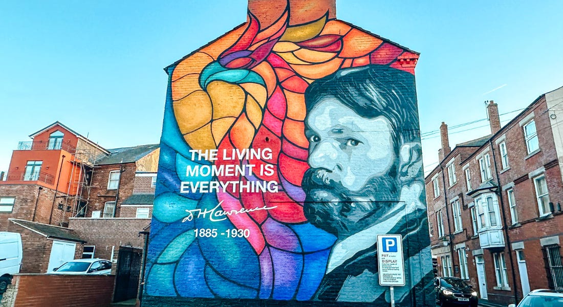 A house with a DH Lawrence mural painted onto the side of it, and houses either side A house with a DH Lawrence mural painted onto the side of it, and houses either side