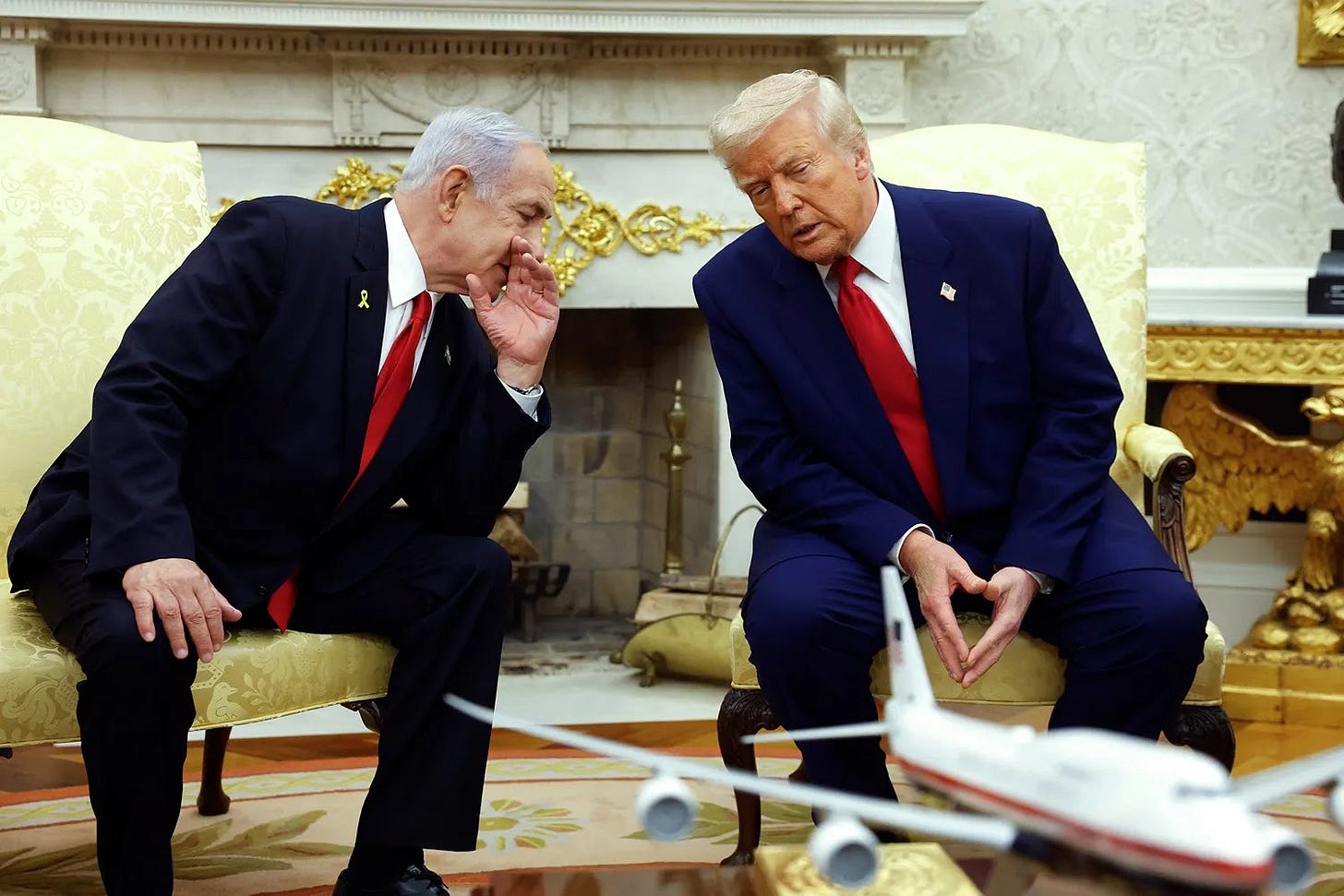 Israeli Prime Minister Benjamin talks to U.S. President Donald Trump during a meeting at the White House.