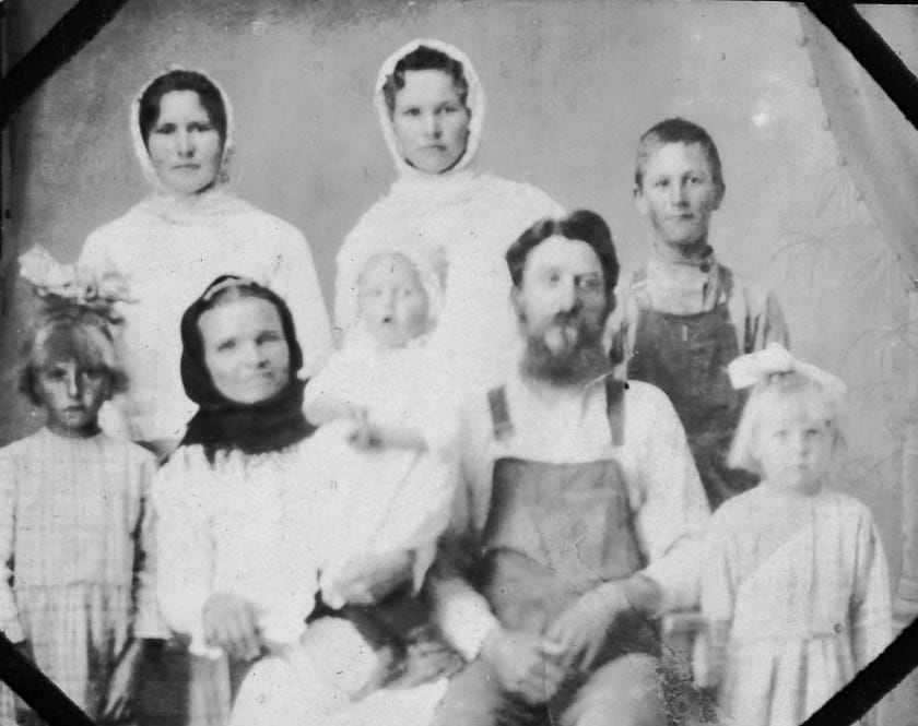 Formal portrait of a Russian Molokan family in Valle de Guadalupe in the early twentieth century, showing three women in white kerchiefs, a bearded patriarch in overalls, and several children. Formal portrait of a Russian Molokan family in Valle de Guadalupe in the early twentieth century, showing three women in white kerchiefs, a bearded patriarch in overalls, and several children.