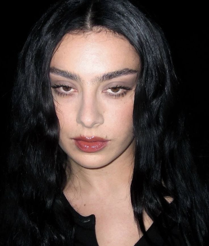 This may contain: a close up of a person with long black hair and brown eyeshadow wearing red lipstick This may contain: a close up of a person with long black hair and brown eyeshadow wearing red lipstick