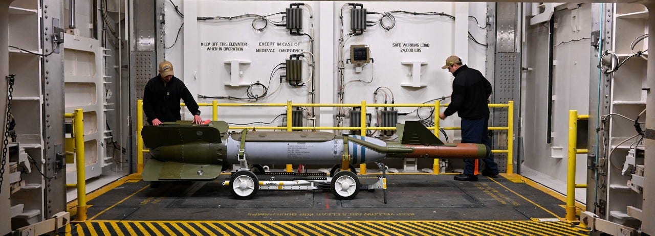 Soldiers move U.S. missile aboard aircraft carrier