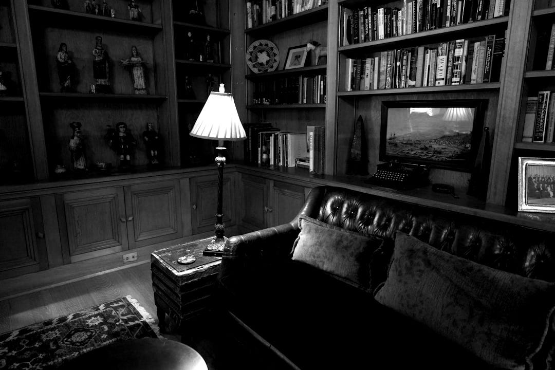 A living room filled with lots of books and furniture