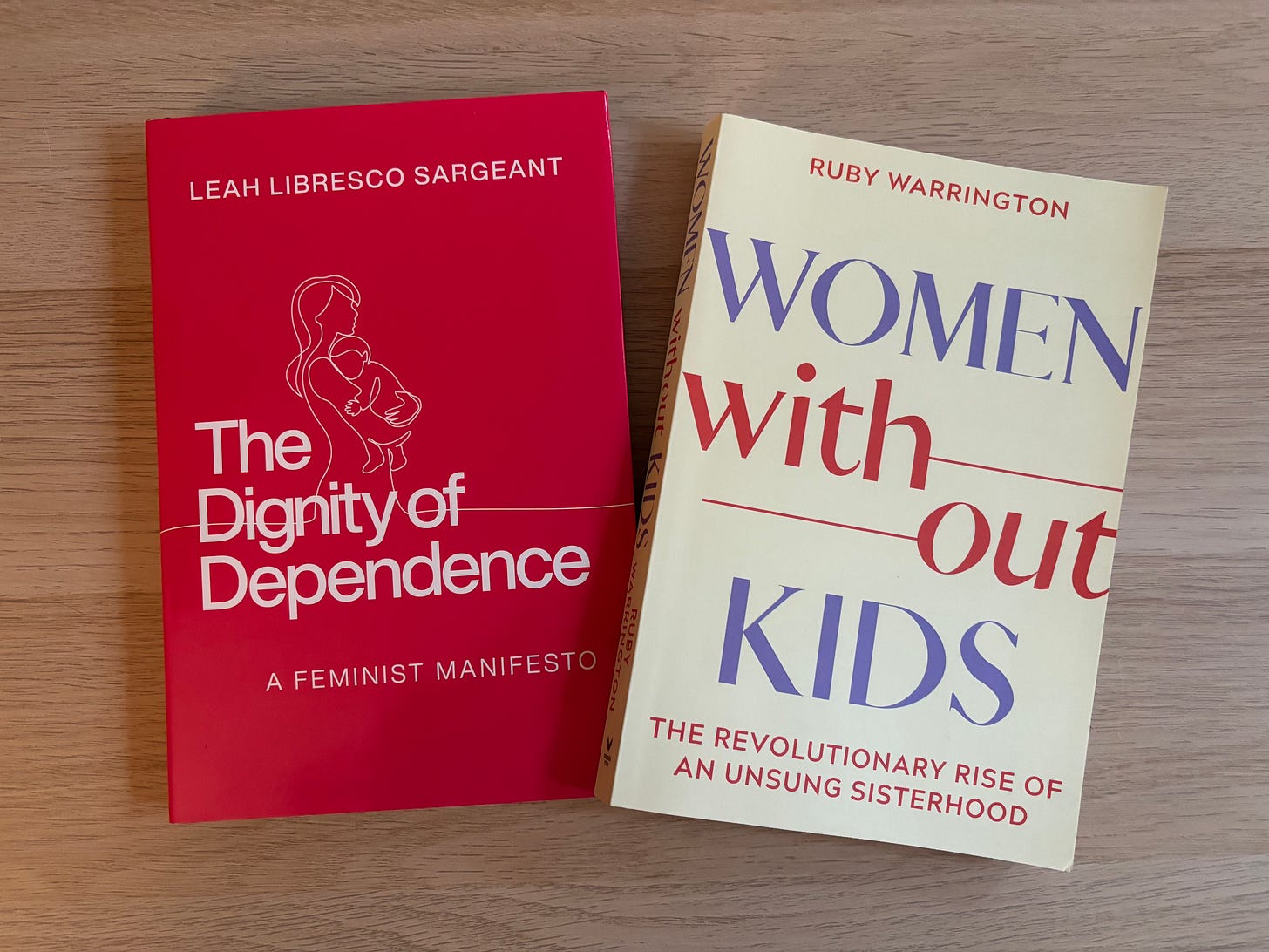 Two books, "Women Without Kids" and "Dignity of Dependence" sit on my coffee table.