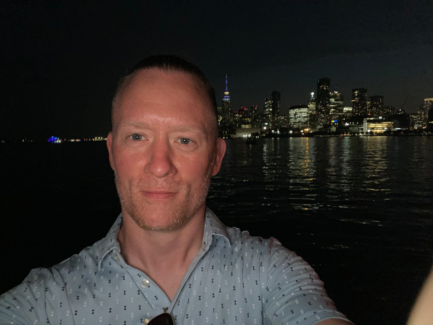 A selfie of Jeremy in front of the Toronto skyline