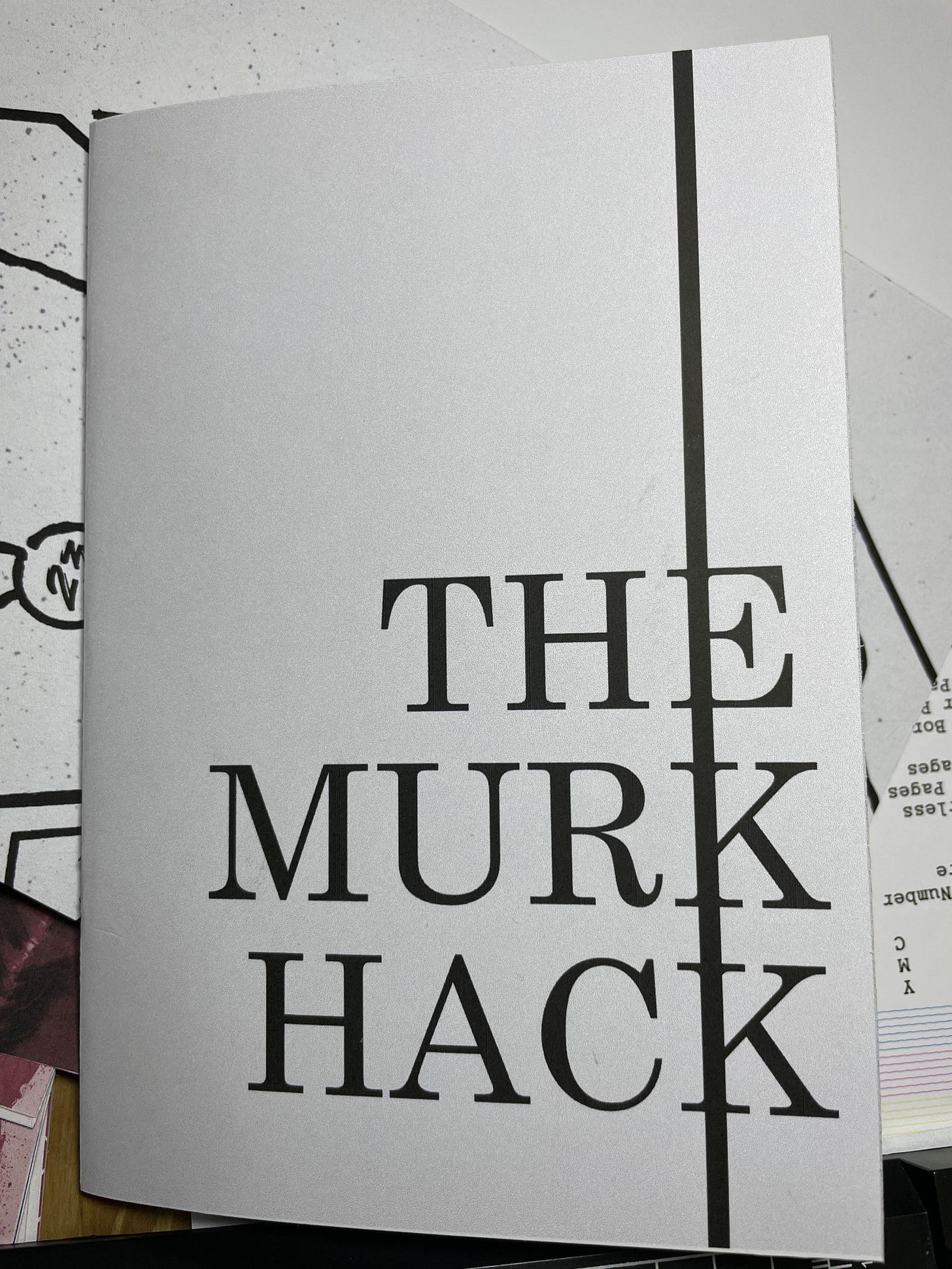 A grey booklet titled The Murk Hack