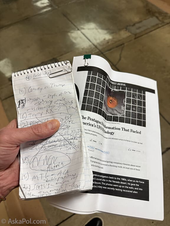 Hand holds a notebook and article. Photo: Matt Laslo © Askapoluap.com